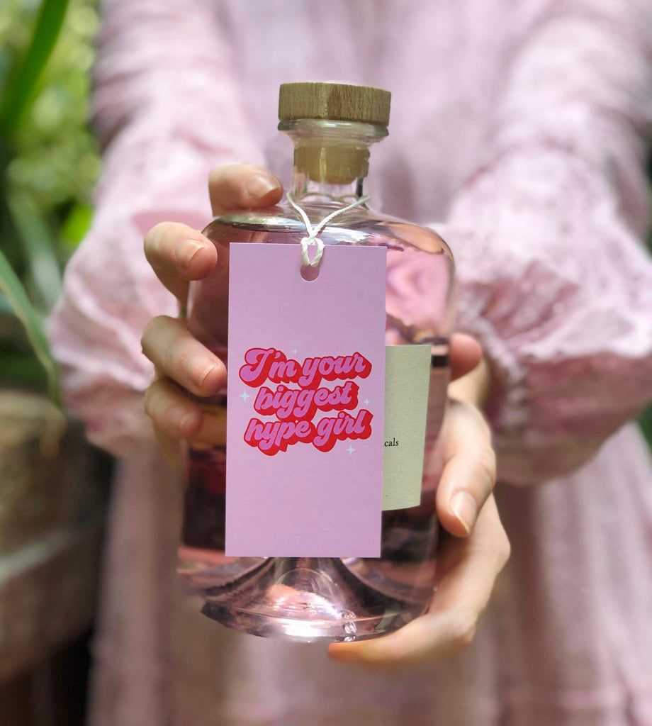 Bad on Paper pink gift tag that reads "I'm your biggest hype girl". Gift tag specification are 5cm x 10cm, printed on premium 400gsm. This gift tag is perfect for birthdays, appreciation and here for you moments. Last minute gift idea on the go. This gift tag is perfect for bottles of wine and alcohol and wrapped gifts and presents. This tag is placed around the neck of a gin bottle. Made in Australia